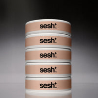 Five cans of Sesh+ Cappuccino nicotine pouches, stacked